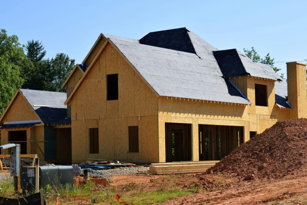 pexels-photo-209266-209266 A partially built wooden house under construction, showcasing its progress and design in daylight.